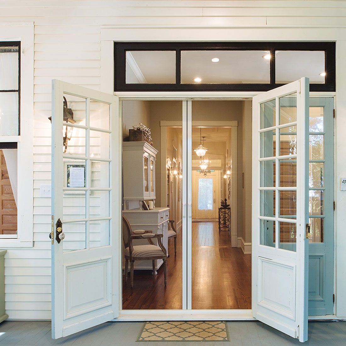 Retractable door screens, mounted on double-French doors.